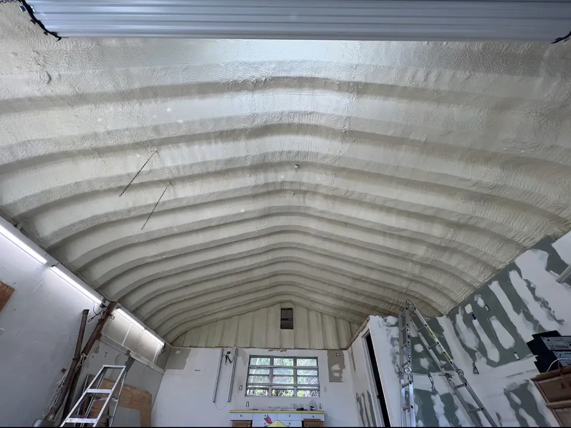 Spray polyurethane foam applied to the underside of a metal roof deck in Potomac Mills